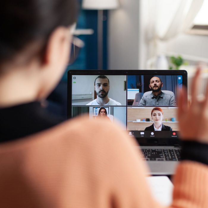 Student in a group videocall on laptop.